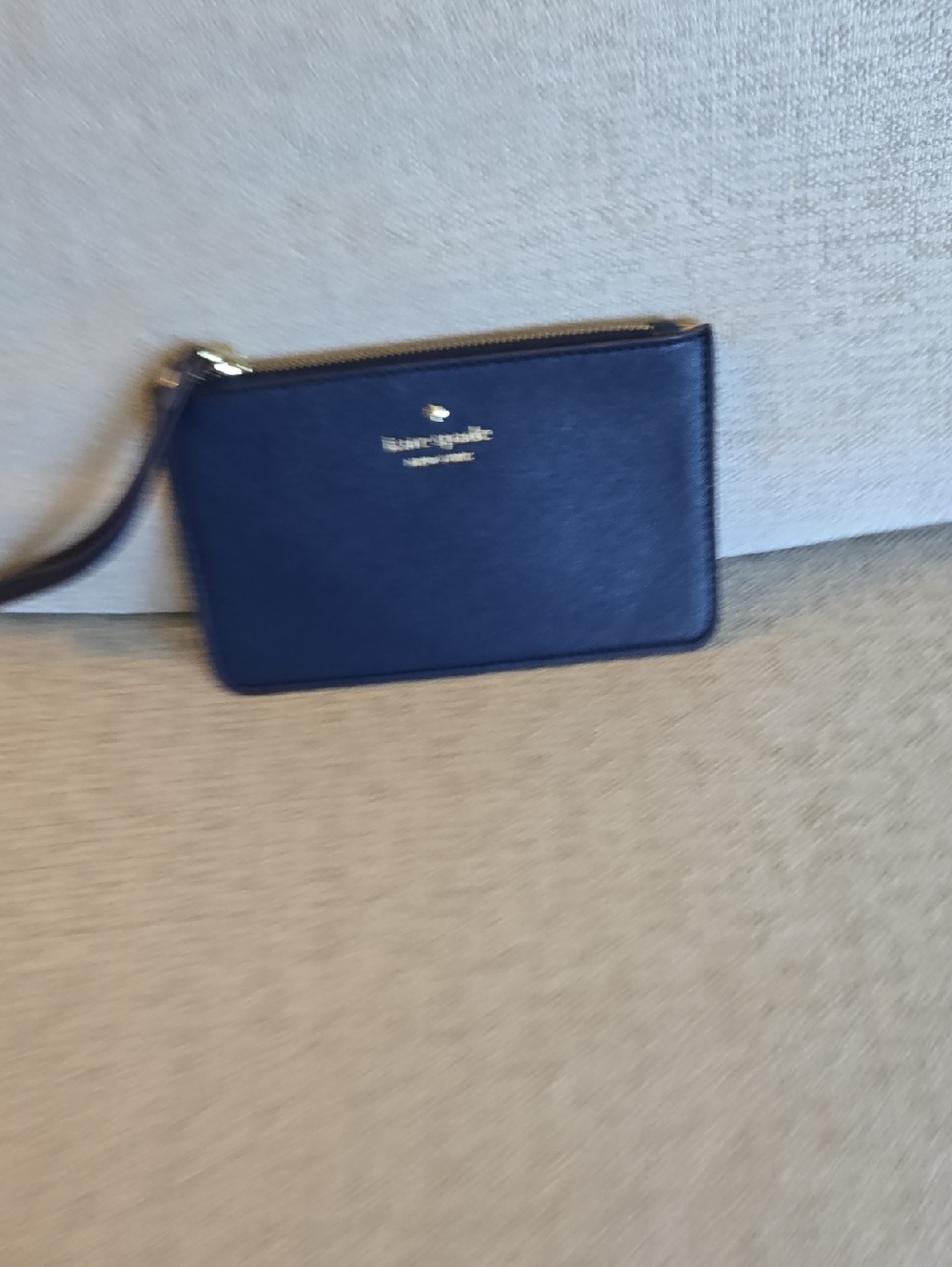 Kate Spade navy leather wristlet with gold logo